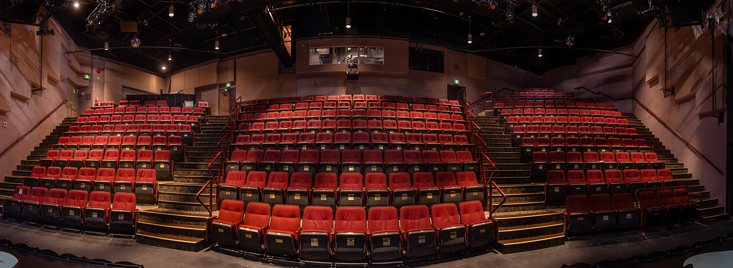 a stretched out version of the chemainus theatre festival seats, red seats with stepped aisles and bannisters